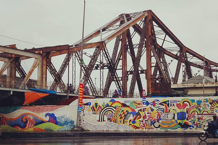Long Bien bridge and the ceramic mosaic mural wall in the same frame